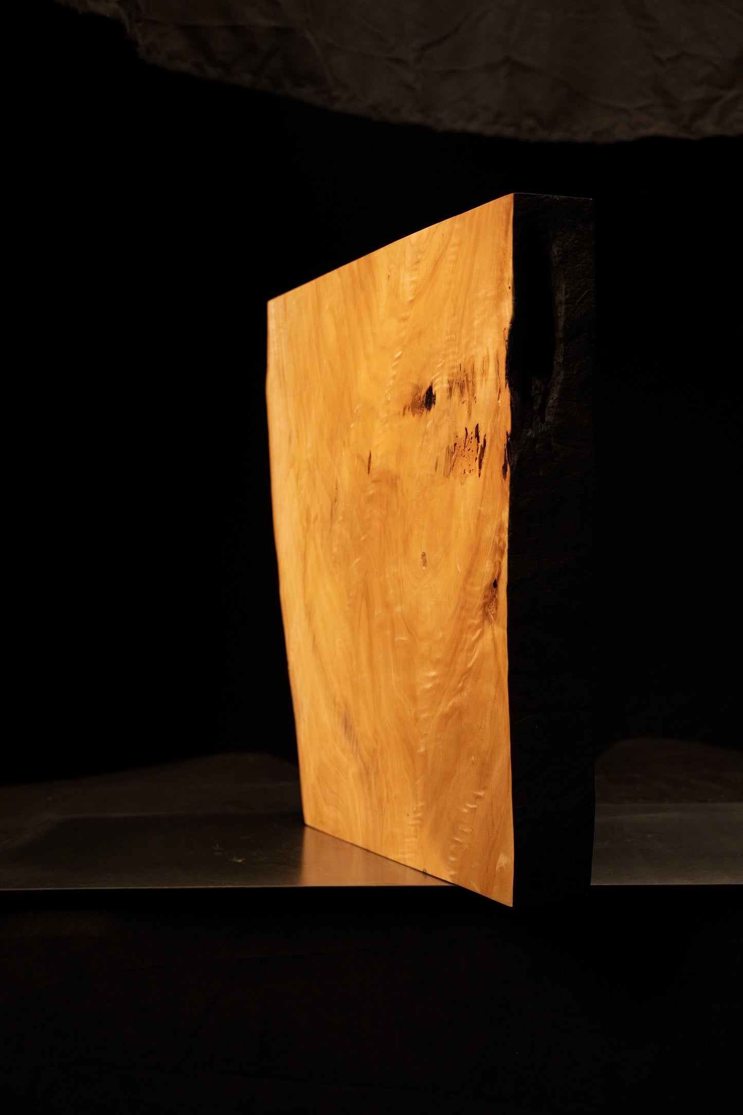 Front angled view of a tall climate-stable structural slab showcasing a wide flat face and a dark textured organic side edge.[cite: 3, 4]