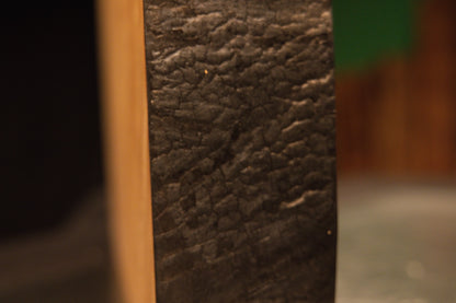 Extreme macro photography of the dark heavily textured botanical edge on an epoxy-free and perfectly stabilized timber piece.[cite: 3, 4]