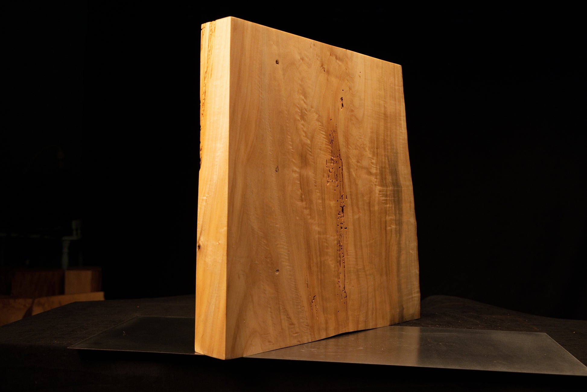 Flat reverse profile of a floor-heating compatible timber slab highlighting straight vertical golden grain and tiny dark knots.  