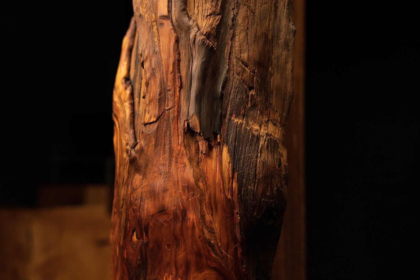 Close-up capturing rich amber hues and deeply furrowed vertical wood fibers on a floor-heating compatible centerpiece. 