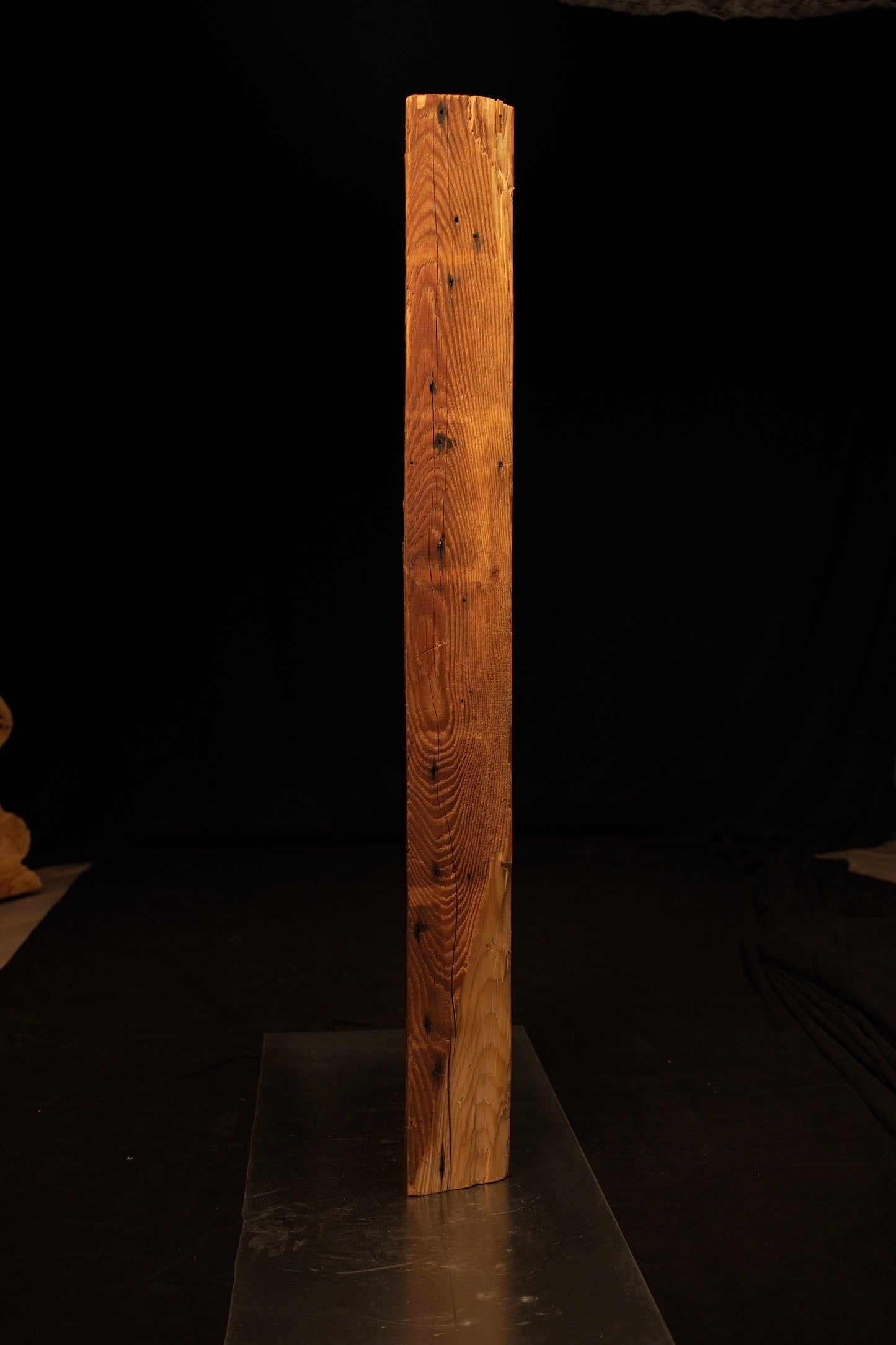 Side profile of a standing epoxy-free architectural wood block highlighting dense vertical grain and a smooth precision cut base. 
