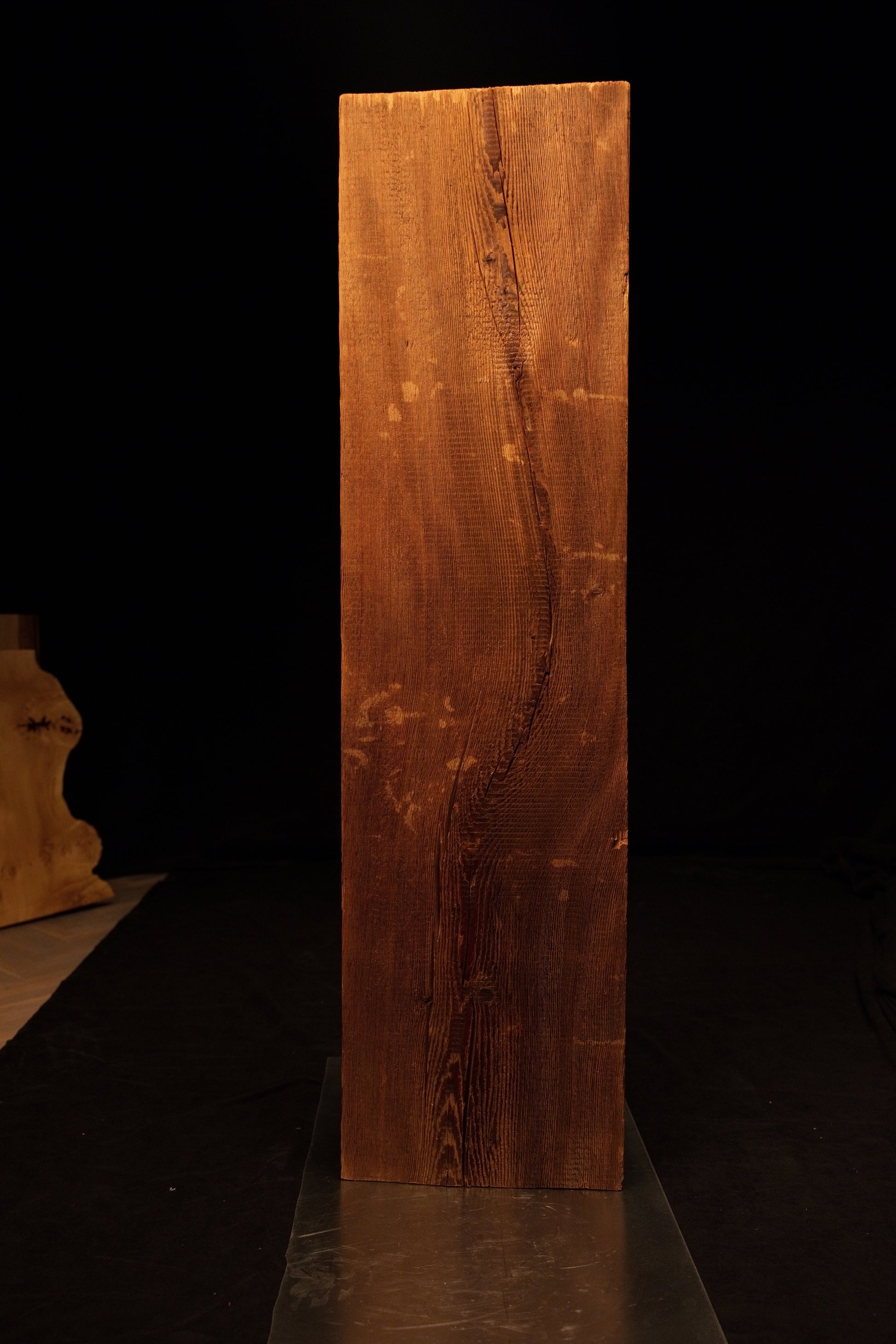 Straight frontal perspective of a tall floor-heating compatible wooden slab showcasing tight vertical grain and a flat top cut. 