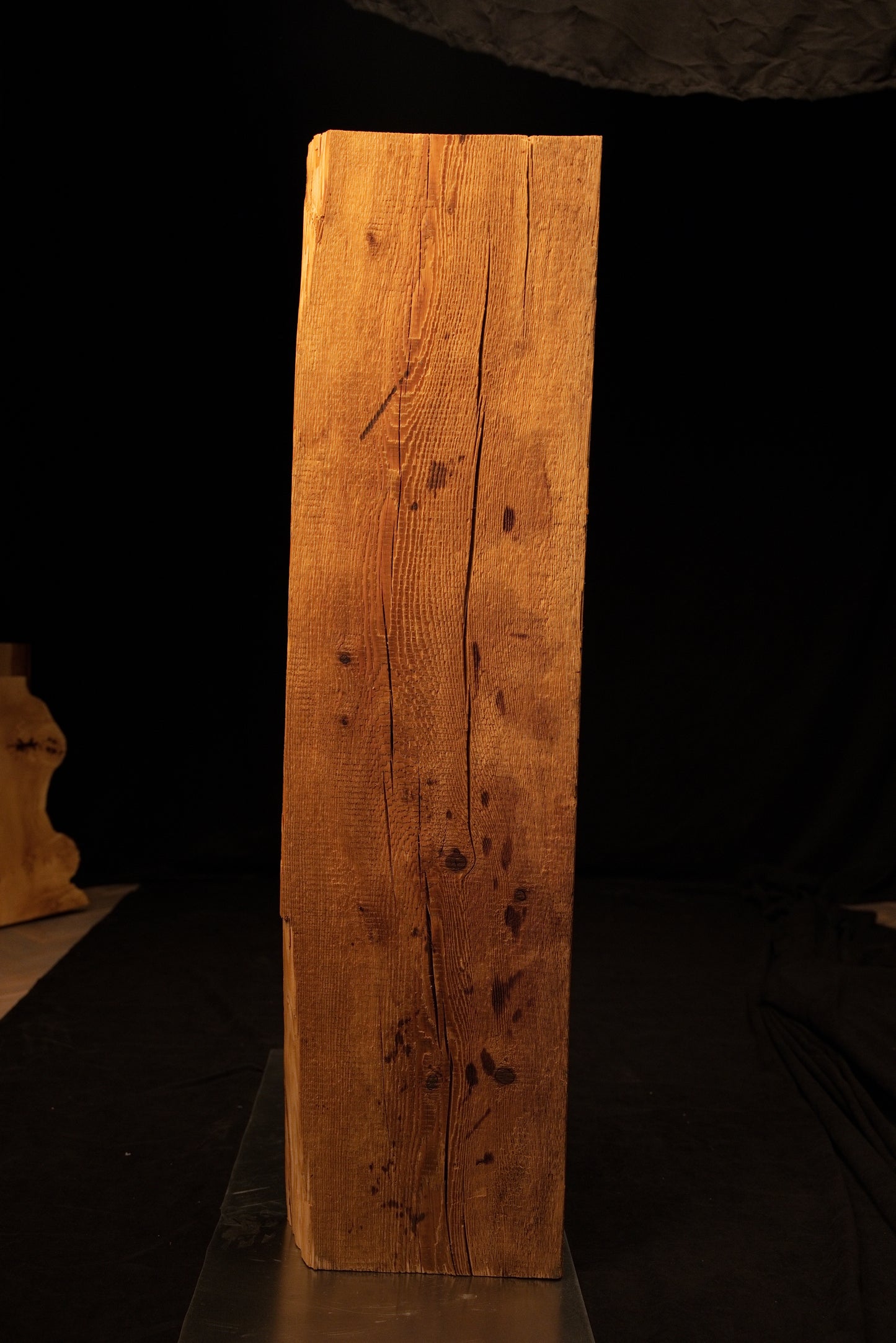 Angled full profile of a completely stabilized interior timber element displaying rich golden hues and distinct surface checking. 