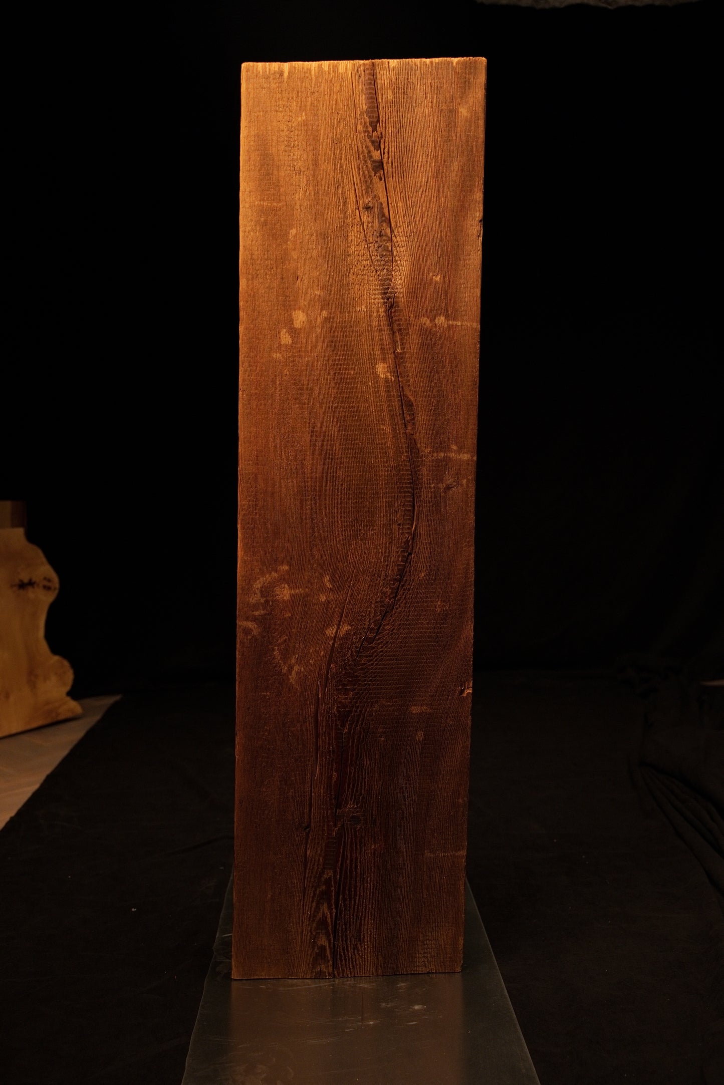 Detailed front view of the highly textured face on a museum-quality biophilic structural centerpiece showing deep wood furrows. 
