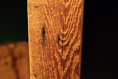 Macro focus on deep vertical furrows and authentic surface scoring displayed on a beautifully preserved biophilic interior wood. 