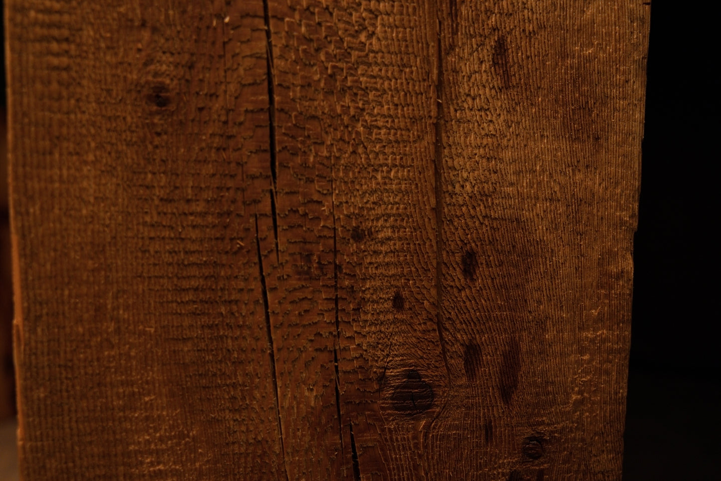Close perspective of scattered dark nail holes and authentic surface scoring on a floor-heating compatible architectural timber. 
