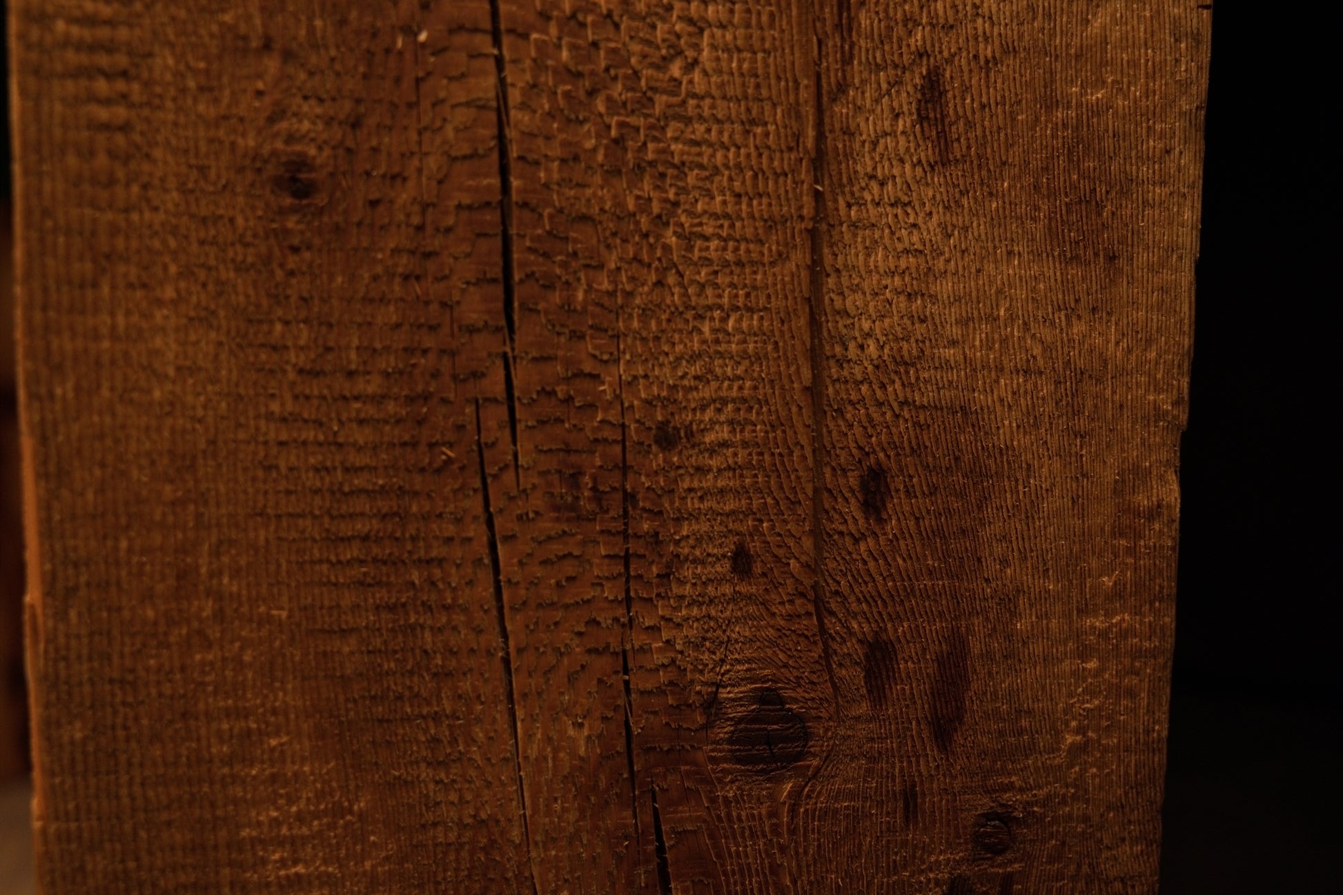 Close perspective of scattered dark nail holes and authentic surface scoring on a floor-heating compatible architectural timber. 