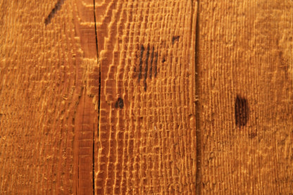 Macro photography revealing dark organic spotting nestled within the deeply furrowed golden grain of an epoxy-free timber slab. 