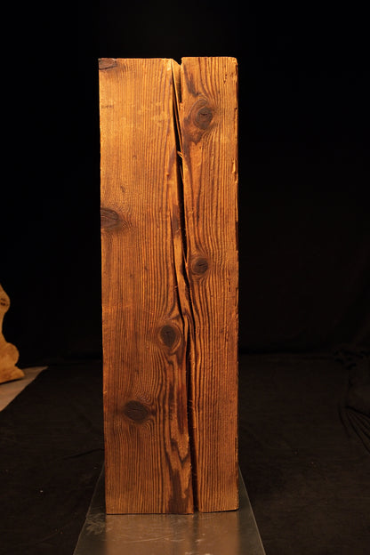 Straight front perspective of a floor-heating compatible wooden block revealing a deep vertical split and natural dark knots. 