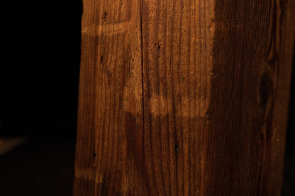 Macro view of a deep vertical fissure splitting the top precision cut edge on a climate-stable architectural timber block. 