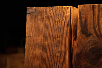 Close detail of a jagged vertical structural split running down the side of a perfectly stabilized biophilic timber element. 