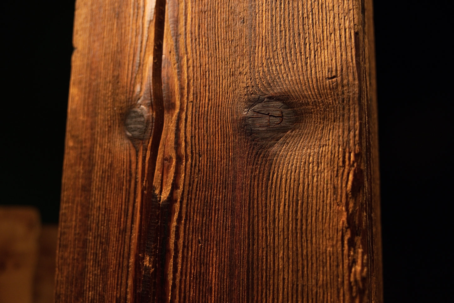 Close detail of a jagged vertical structural split running down the side of a perfectly stabilized biophilic timber element.  