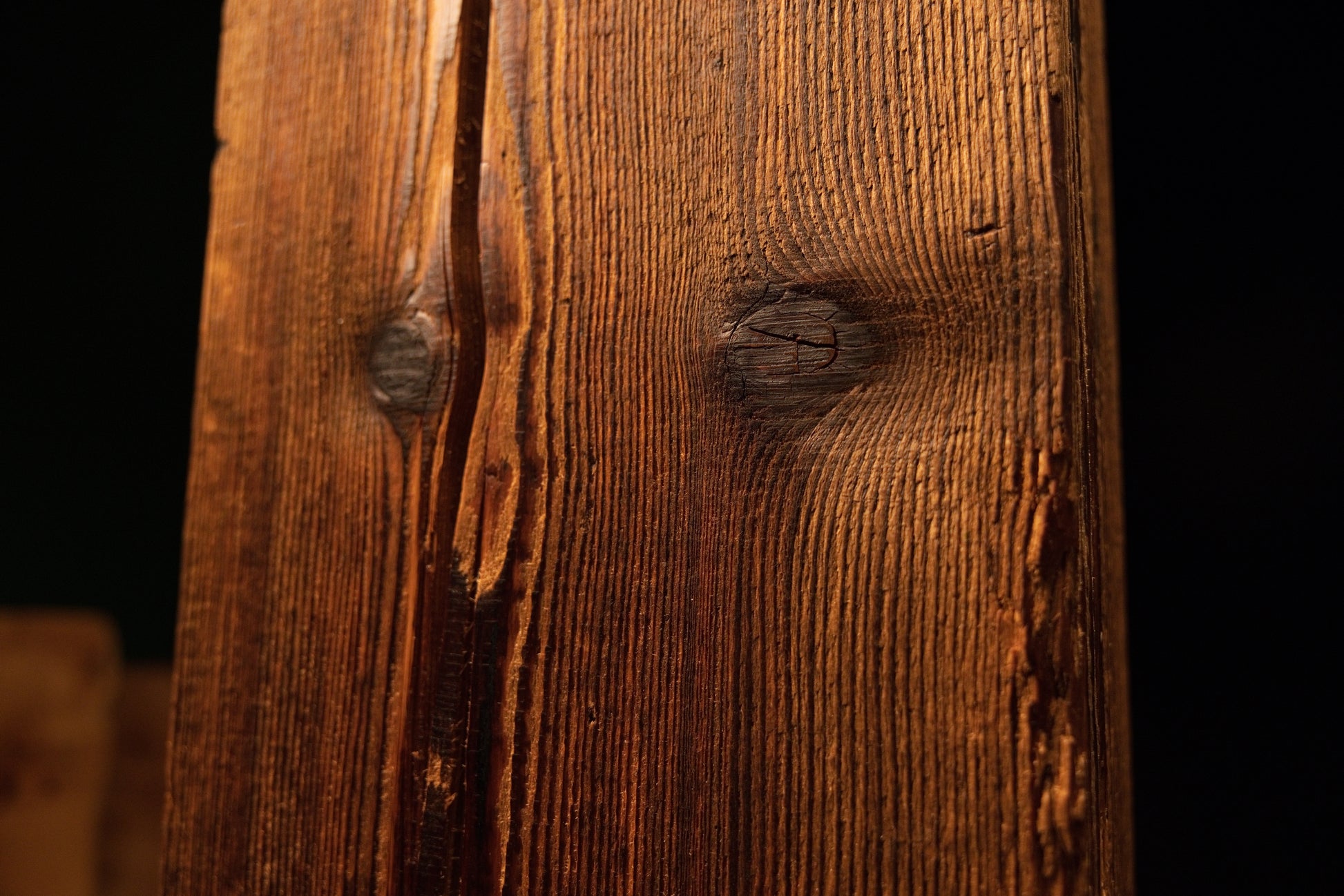 Close detail of a jagged vertical structural split running down the side of a perfectly stabilized biophilic timber element.  