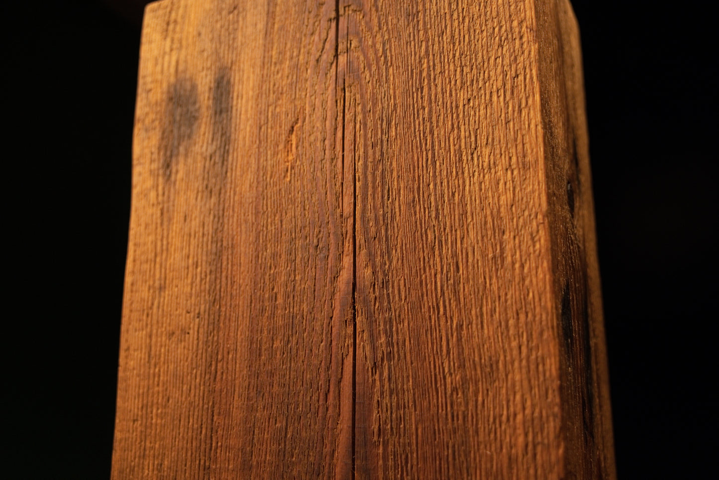 Close detail of straight vertical golden grain and small biological spots on an epoxy-free biophilic interior wooden element.  