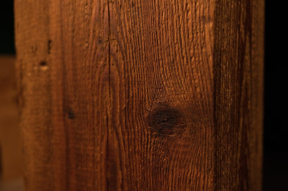 Macro perspective capturing a central dark joinery void surrounded by sweeping grain on a perfectly stabilized botanical log.  