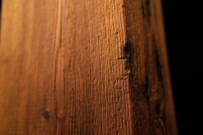 Extreme close-up of a long jagged vertical split running down the face of a floor-heating compatible architectural wood block.  