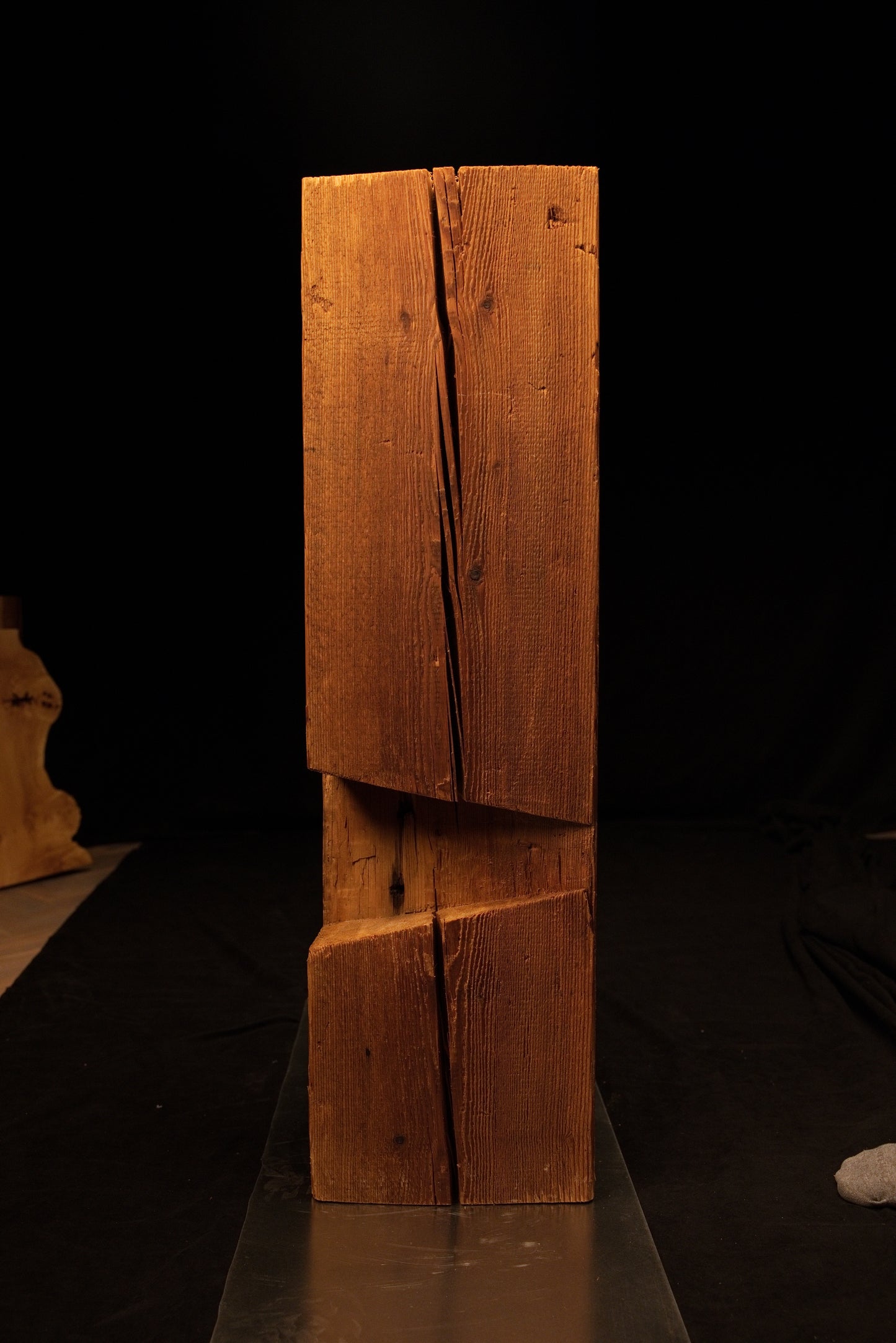Angled side profile of a completely stabilized interior timber element displaying unique interlocking diagonal cuts and a split. 