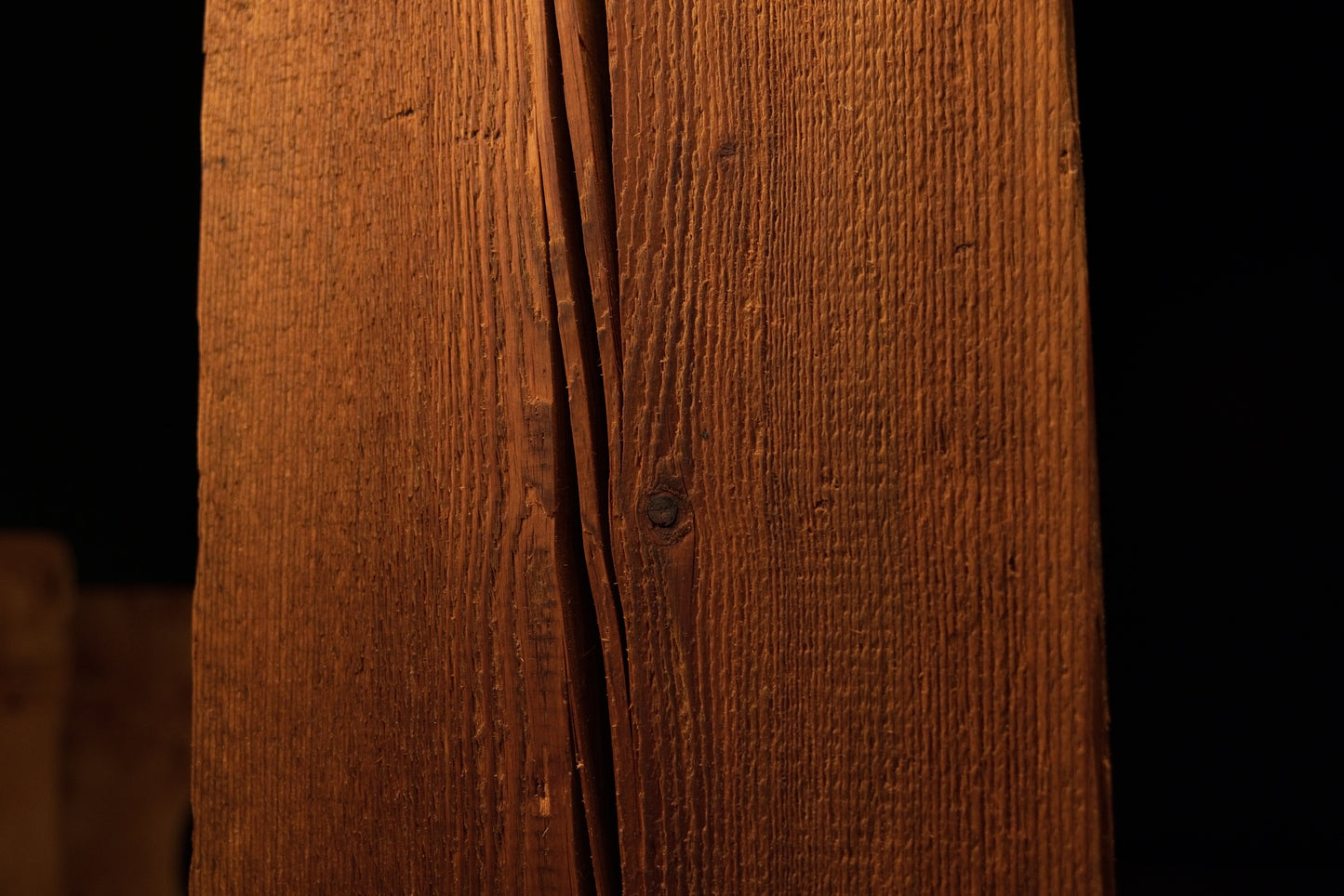 Straight vertical view of a polished wooden block highlighting straight grain lines and minor surface blemishes on the face. 