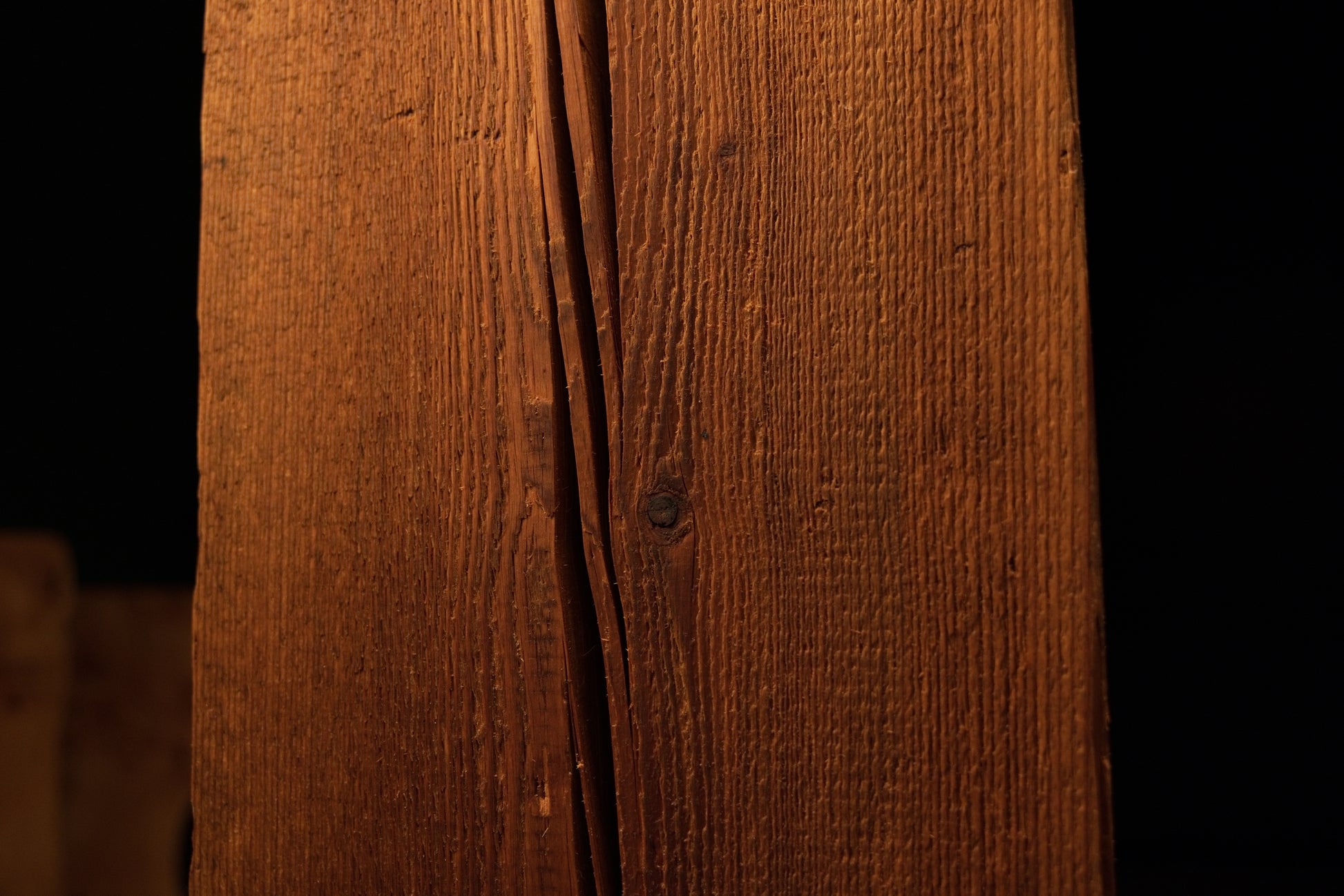 Straight vertical view of a polished wooden block highlighting straight grain lines and minor surface blemishes on the face. 