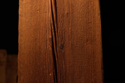 Straight vertical view of a polished wooden block highlighting straight grain lines and minor surface blemishes on the face. 