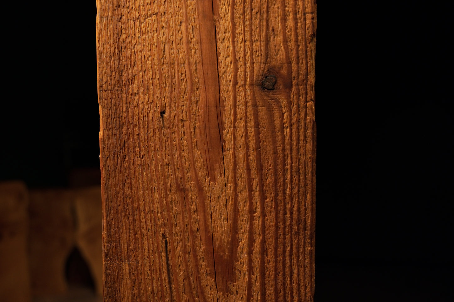 Detailed view of straight vertical golden grain lines running uniformly across the face of a climate-stable timber element. 