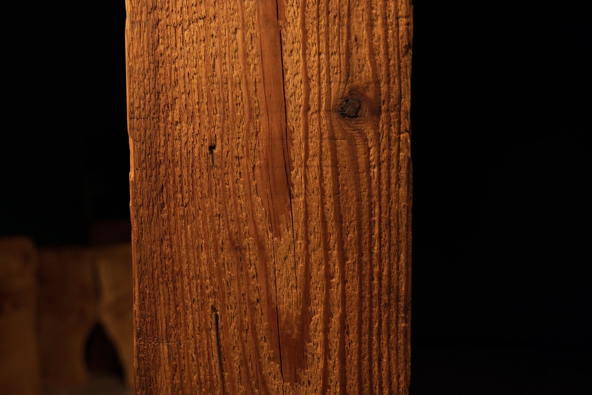Detailed view of straight vertical golden grain lines running uniformly across the face of a climate-stable timber element. 