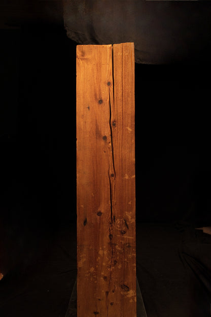 Vertical view of a floor-heating compatible timber element showcasing a prominent central split and multiple dark wood knots. 