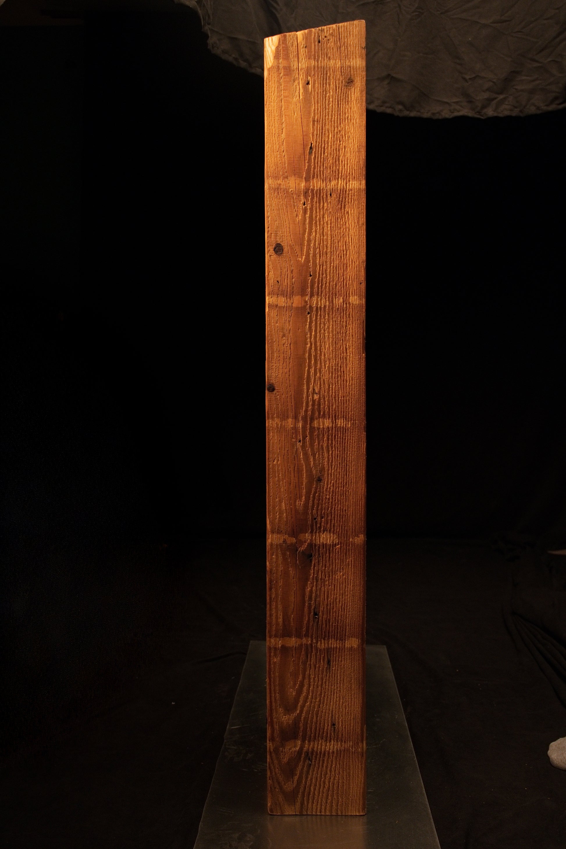Side profile of an epoxy-free commercial structural beam featuring an angled top cut and dense straight vertical grain. 