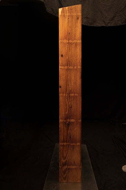 Side profile of an epoxy-free commercial structural beam featuring an angled top cut and dense straight vertical grain. 