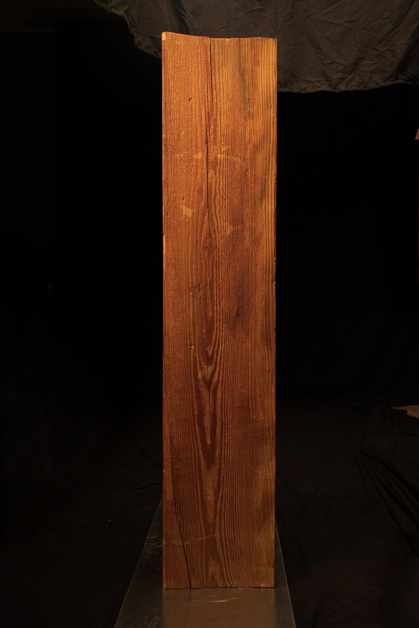 Full standing elevation of a museum-quality biophilic wooden monolith displaying rich golden hues and uniform vertical lines. 