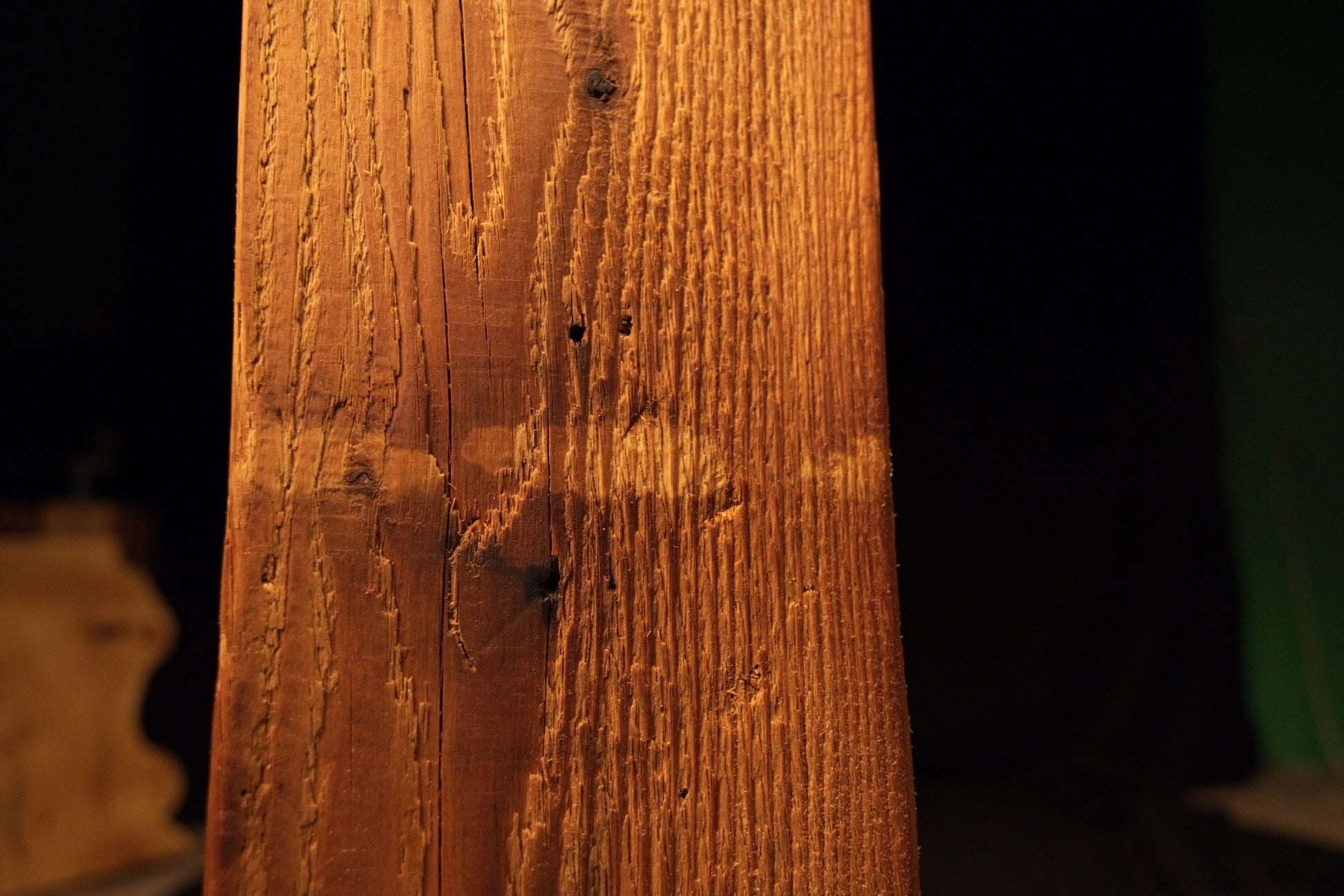 Detailed macro perspective capturing fine horizontal milling lines cutting across the vertical grain patterns of the structural beam. 