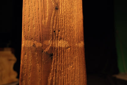 Detailed macro perspective capturing fine horizontal milling lines cutting across the vertical grain patterns of the structural beam. 