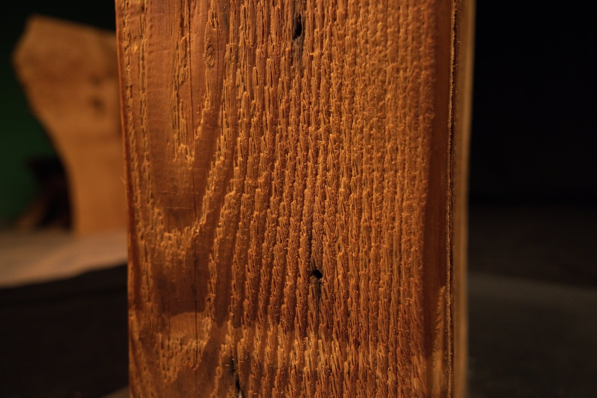 Detailed close-up view of the upper beam section displaying clean vertical wood grain lines alongside a single small dark pinhole. 