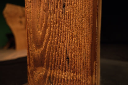 Detailed close-up view of the upper beam section displaying clean vertical wood grain lines alongside a single small dark pinhole. 