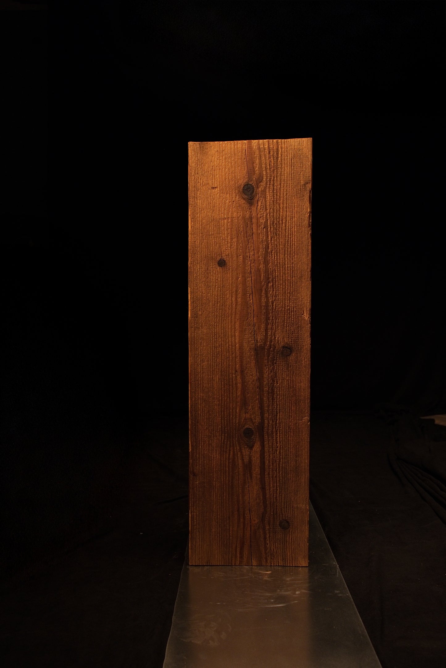 Straight front elevation of a rectangular timber column showcasing uniform vertical grain patterns and warm brown tones. 