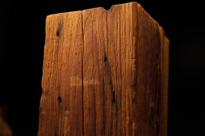 Detailed view of the upper beam section featuring tiny pinholes and dark knot marks along a fine vertical crack. 