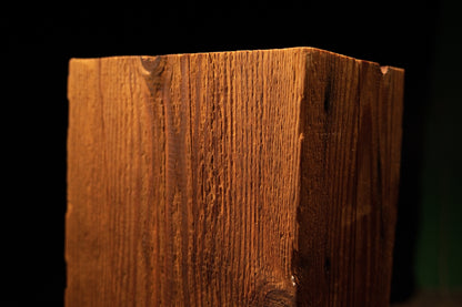 Close-up view of the upper corner section on the timber post displaying clean vertical grain and a dark knot. 