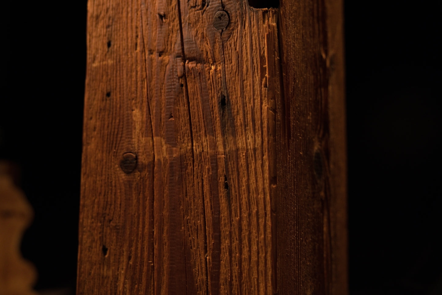 Macro view of the upper beam section featuring multiple scattered pinholes and dark knot formations. 