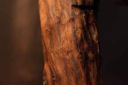 Close-up of the upper portion showing a small horizontal notch cut and rich, highly textured natural wood grain patterns. 