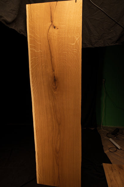 Front elevation of a custom solid oak architectural panel displaying distinct medullary rays, a central fissure, and a dark knot.