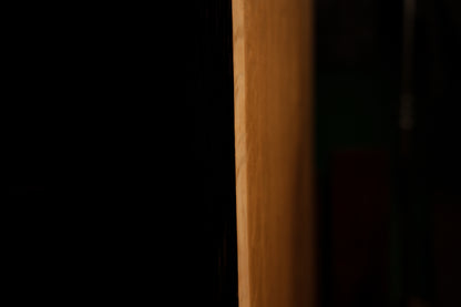 Detailed macro photograph capturing prominent sweeping medullary ray patterns intersecting vertical grain on the oak board.