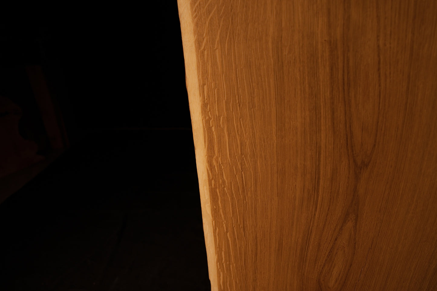 Close-up view of the precision milled side edge on the solid oak architectural panel displaying straight vertical grain.