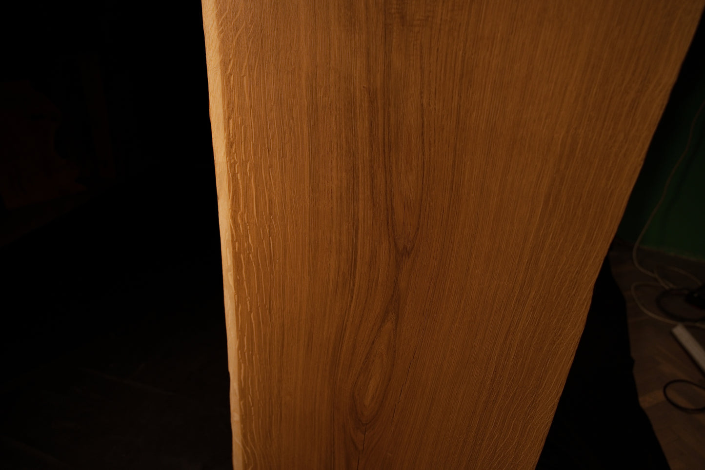 Detailed side profile edge of the custom oak architectural panel revealing clean precision milling and warm golden grain color.