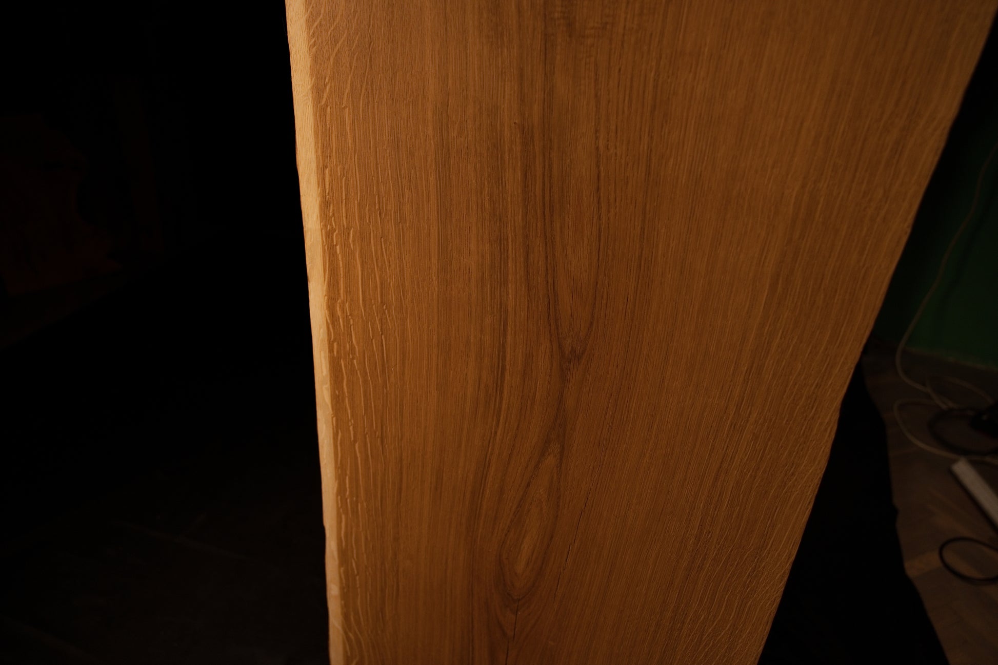 Detailed side profile edge of the custom oak architectural panel revealing clean precision milling and warm golden grain color.
