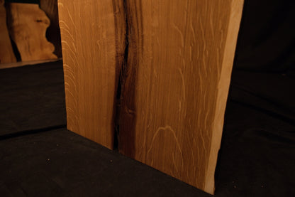 Macro view of natural chatoyancy and shimmering light reflection across quartersawn medullary rays on the premium oak board. 