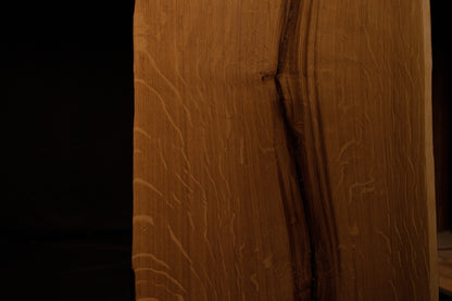 Detailed extreme close-up of shimmering medullary rays catching light along the angled side edge of the custom solid oak panel. 