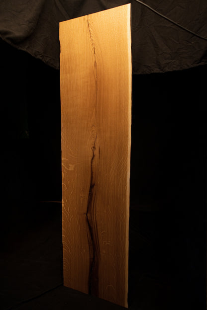 Full frontal elevation of the solid oak architectural panel featuring a dark central split and rich quartersawn wood textures. 