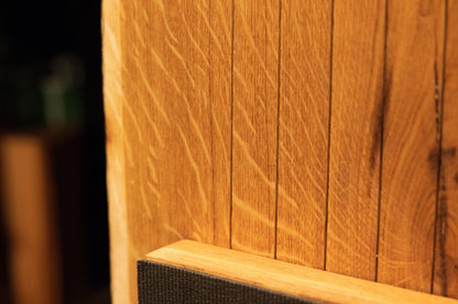 Macro perspective highlighting natural medullary ray figures running near the horizontal support bar on the oak board. 