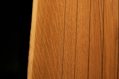 Detailed close-up showing uniform vertical wood slats and fine grain alignment across the face of the custom oak structure. 