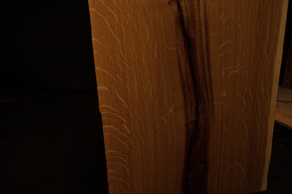 Macro perspective showing intricate quartersawn wood ray figures and fine vertical grain lines on the custom oak panel face. 